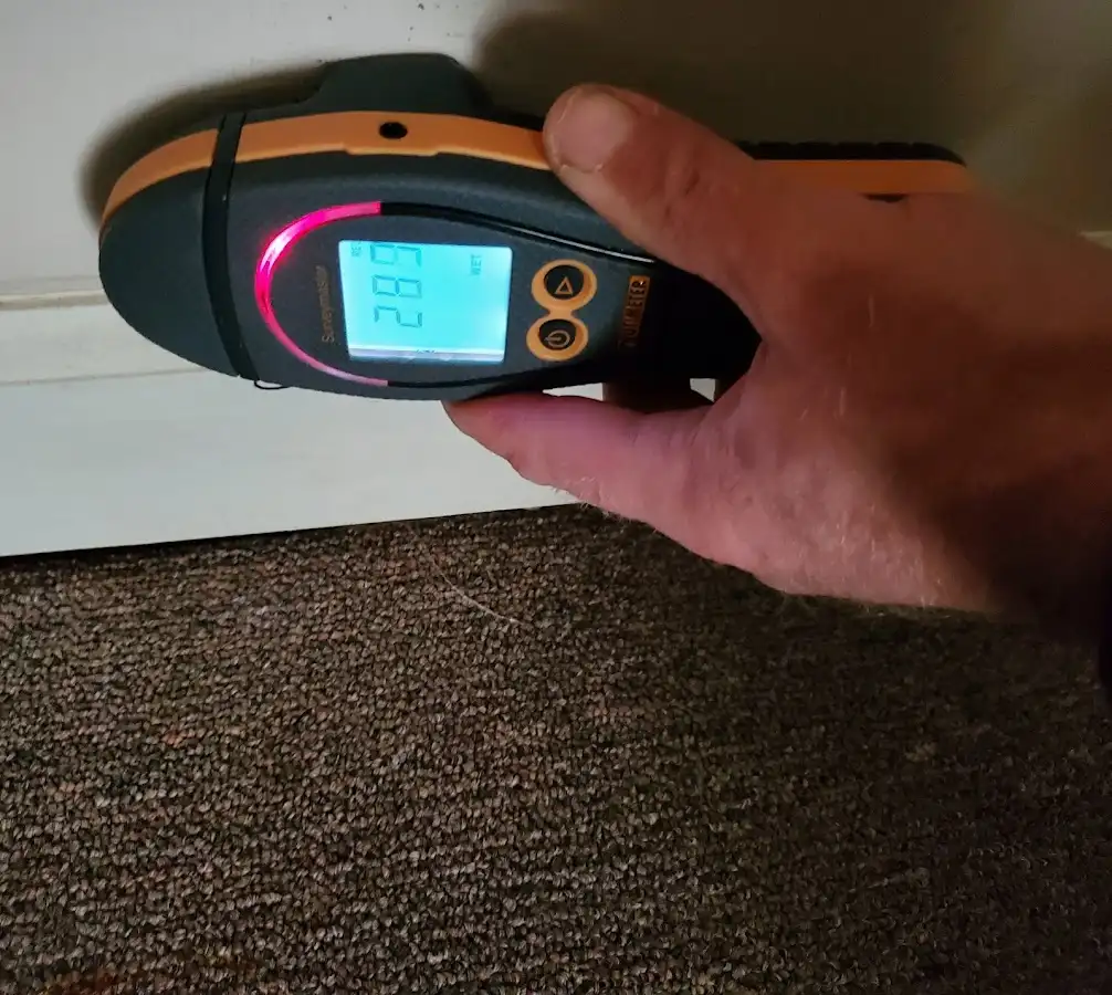 Moisture detection at baseboard during Storm Damage Restoration in Pensacola